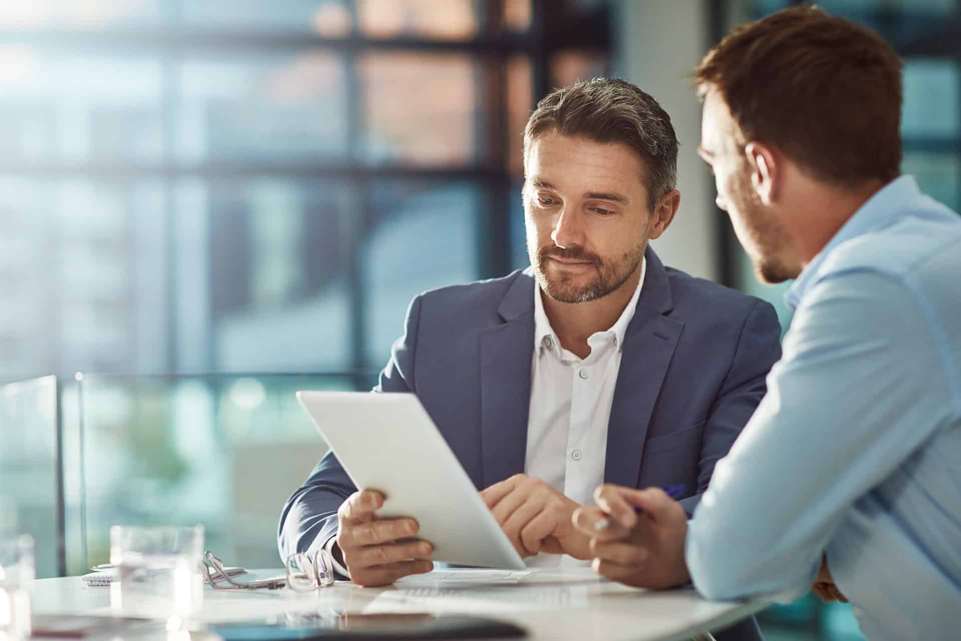 Business professionals discussing leadership strategies in a modern office.